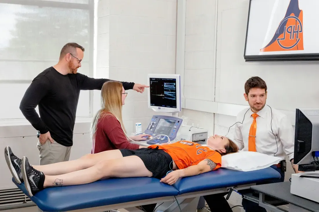 Students and faculty working on the exercise science laboratory.